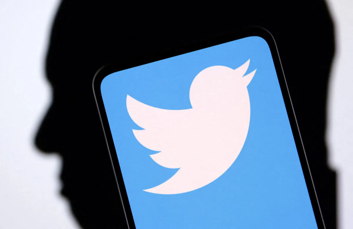 Twitter logo and Elon Musk silhouette in an illustration taken on Dec. 19, 2022. (Dado Ruvic/Reuters)