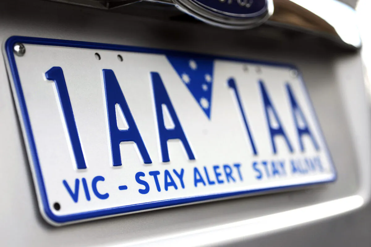 Victorian Premier Denis Napthine unveiled the new Victorian car number plates in Melbourne, Jun. 10, 2013. (AAP Image/Joe Castro)