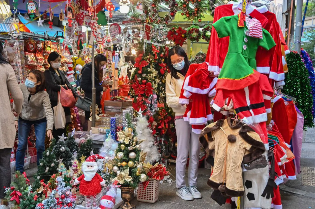 People shop for Christmas items at a market in Hong Kong on Dec. 12, 2022. (Peter Parks/AFP via Getty Images)
