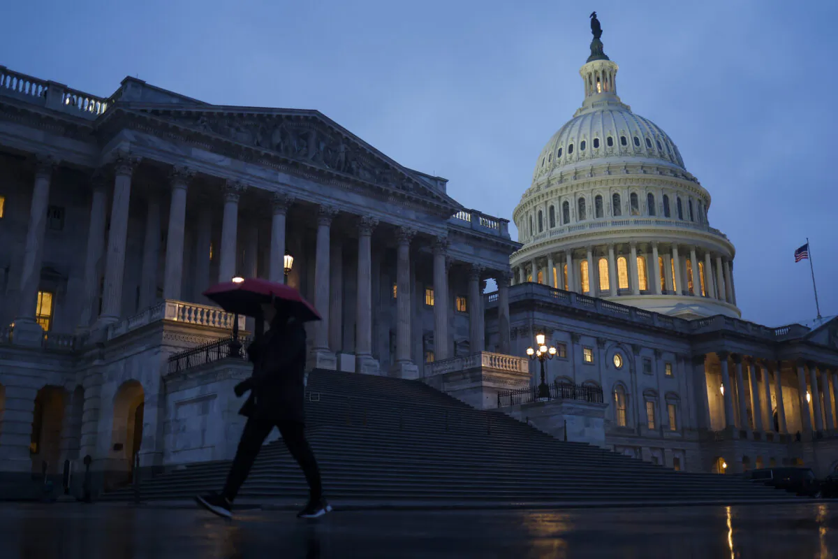 A person walks through the rain near the U.S. Capitol Building in Washington, on Dec. 22, 2022. (Anna Moneymaker/Getty Images)