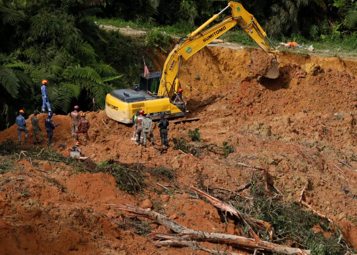 Rescuers work during a rescue and evacuation operation following a landslide at a campsite in Batang Kali, Selangor, Malaysia, on Dec. 17, 2022. (Hasnoor Hussain/Reuters)