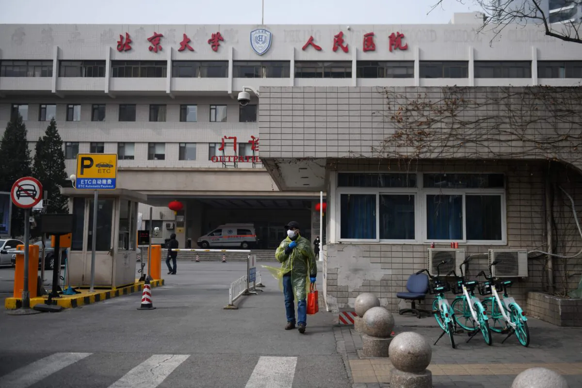 A man walks outside the Peking University People's Hospital in Beijing on Feb. 21, 2020. (Greg Baker/AFP via Getty Images)