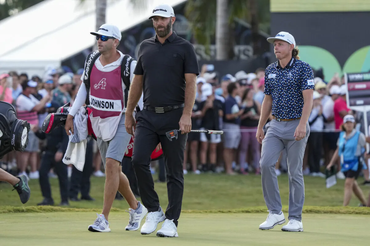 Team Captain Dustin Johnson of 4 Aces GC Team Captain Cameron Smith of Punch GC walk towards the 18th green during the team championship stroke-play round of the LIV Golf Invitational - Miami at Trump National Doral Miami in Doral, Fla., on Oct.30, 2022. (Eric Espada/Getty Images)