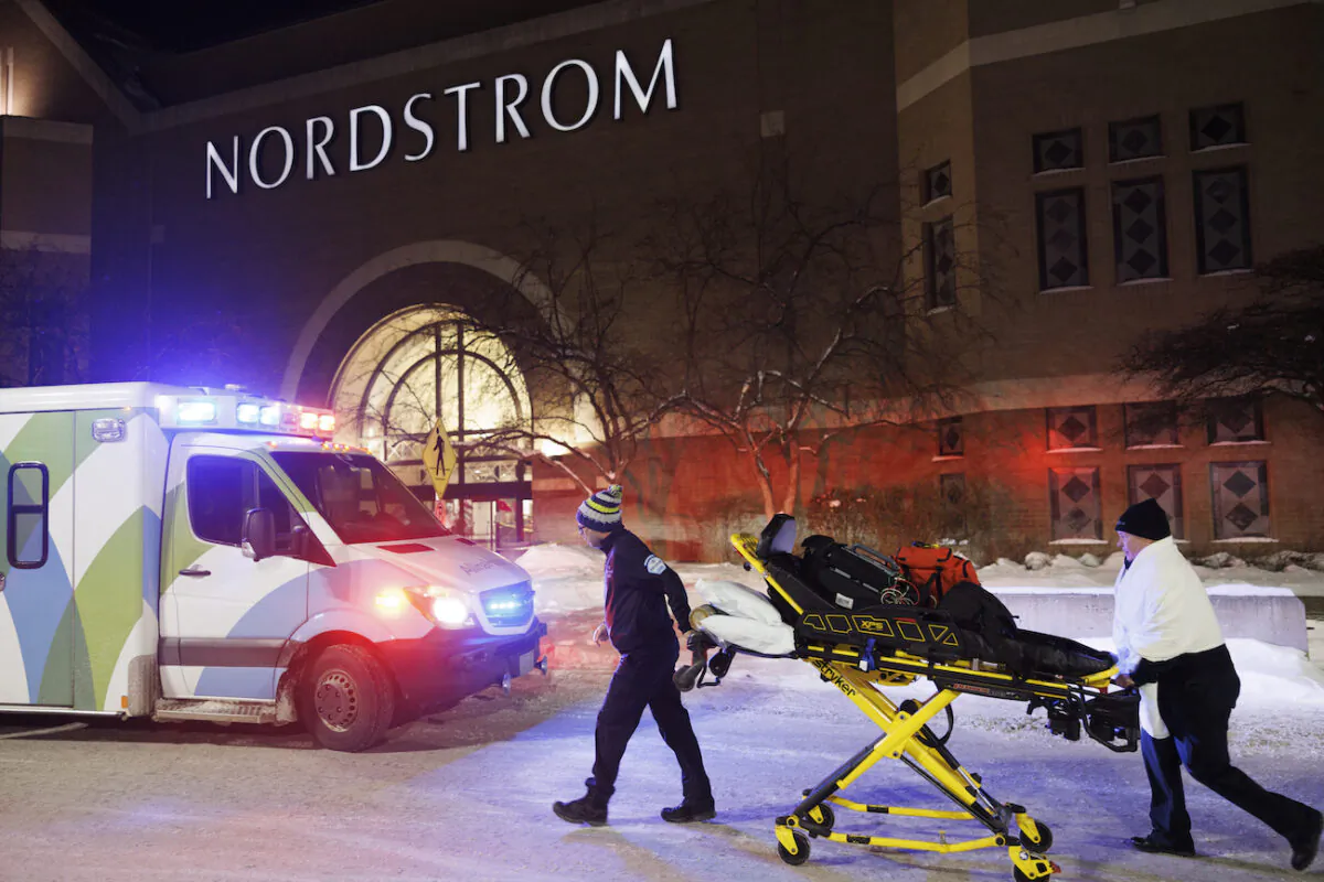 Two first responders and an ambulance are seen after reports of shots fired at the Mall of America in Bloomington, Minn., on Dec. 23, 2022. (Kerem Yücel/Minnesota Public Radio via AP)