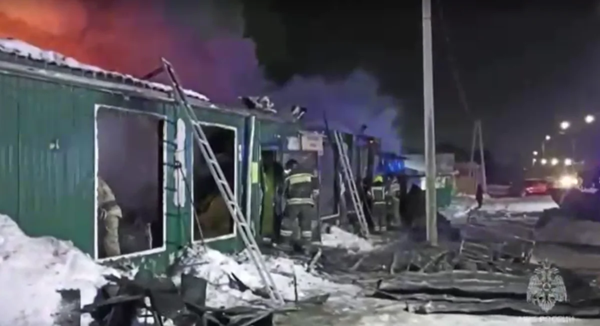 Firefighters battle a blaze at an unregistered home for the elderly in the Siberian city of Kemerovo, Russia, in a still from video released on Dec. 24, 2022. (Russian Emergencies Ministry via Reuters/Screenshot via The Epoch Times) 