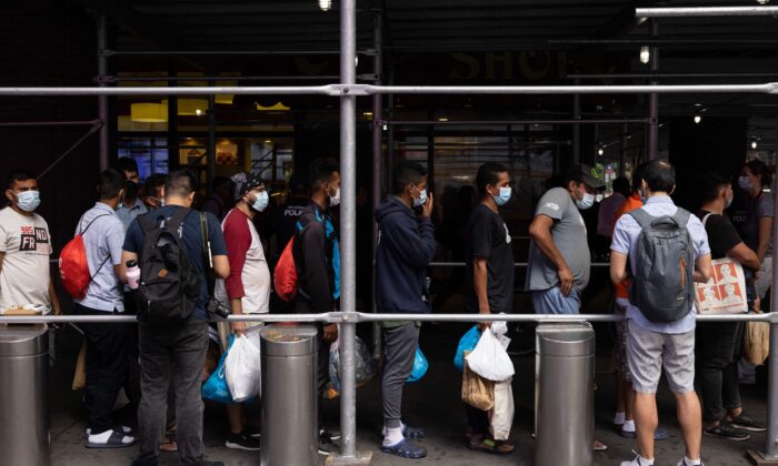 A group of migrants from Texas wait in line outside Port Authority Bus Terminal to receive humanitarian assistance in New York on Aug. 10, 2022. (Yuki Iwamura/AFP via Getty Images)