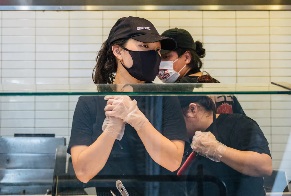 Employees are shown working at a Chipotle Mexican Grill in Houston, Texas, on June 9, 2021. (Photo by Brandon Bell/Getty Images)