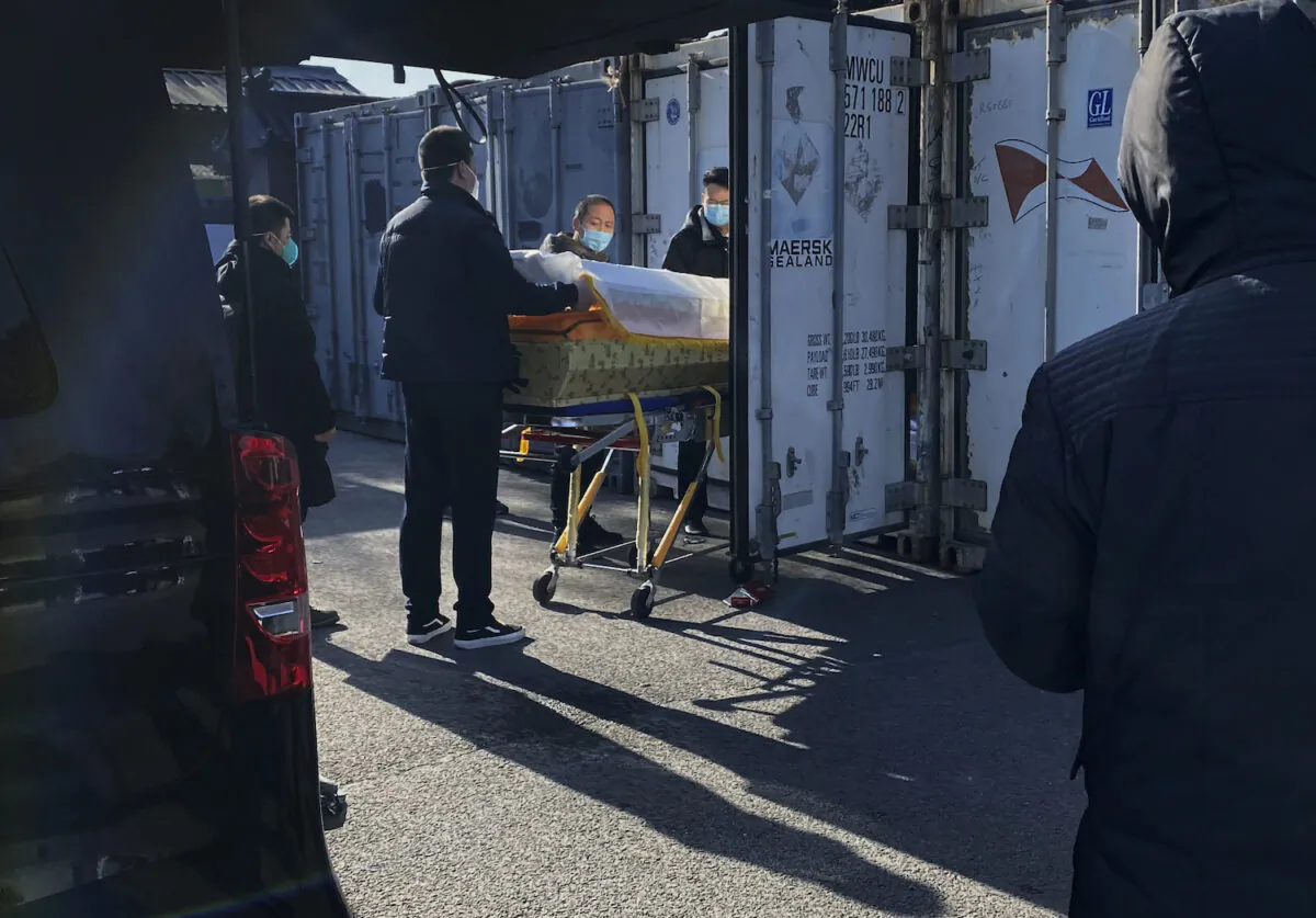 A coffin is loaded from a hearse into a storage container at the Dongjiao crematorium and funeral home, one of several in the city that handles COVID-19 cases in Beijing, China on Dec. 18, 2022. (Getty Images)