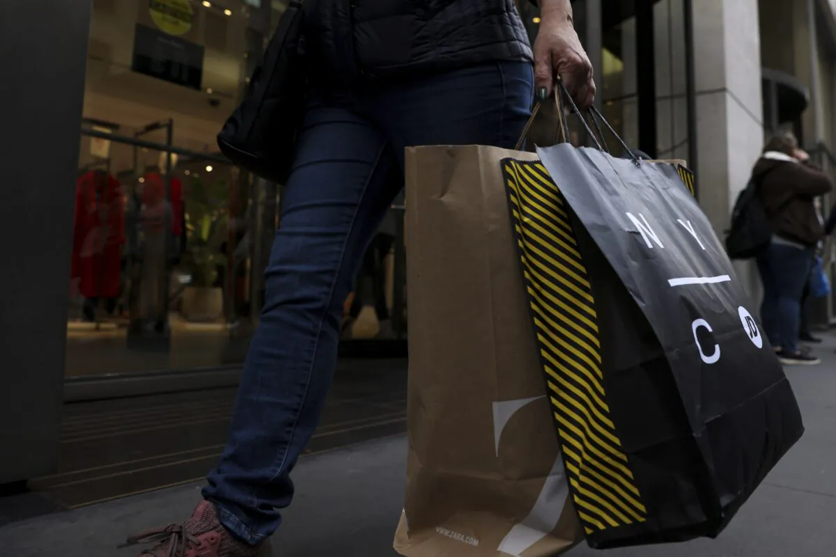 A shopper carries bags down Fifth Avenue in New York on Black Friday Nov. 25, 2022. (Julia Nikhinson/AP Photo)