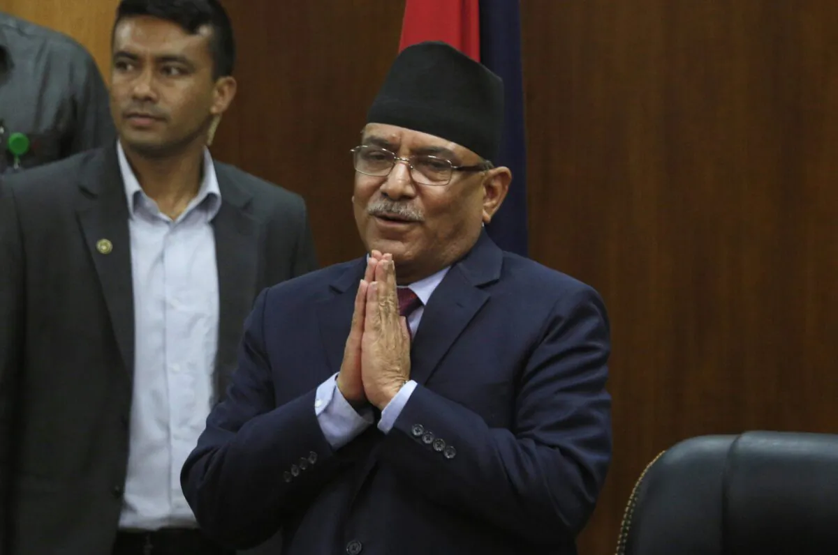 Leader of communist party Nepal, Pushpa Kamal Dahal, greets the gathering after announcing his resignation as prime minister, in line with an agreement made with his coalition partner party, in Kathmandu, Nepal, on May 24, 2017. (Niranjan Shrestha/AP Photo)