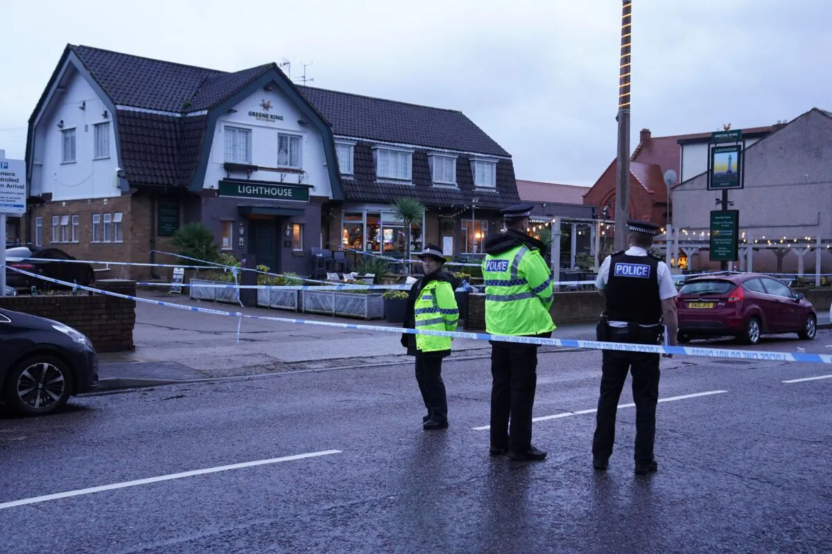 Police officers at the scene of a Christmas Eve shooting at the Lighthouse Inn in Wallasey Village, England, on Dec. 25, 2022. (Peter Byrne/PA Media)