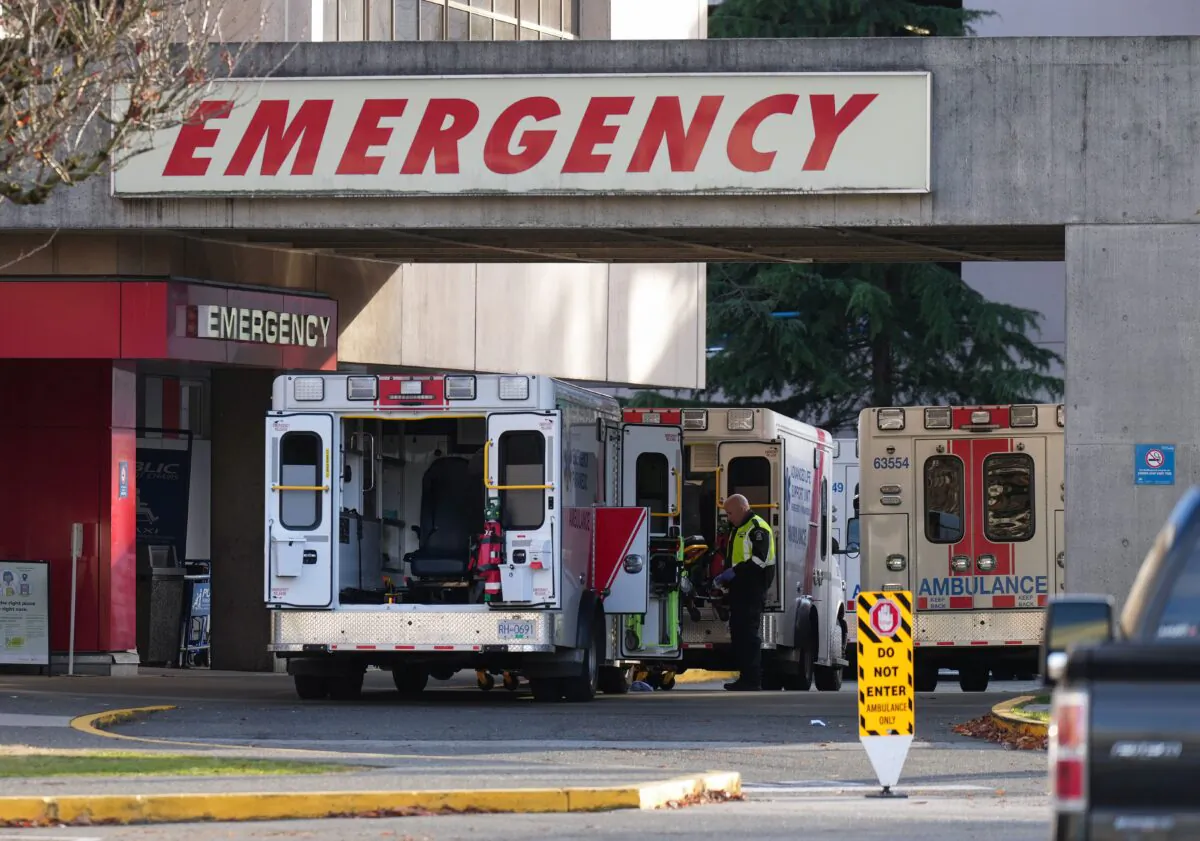 Ambulances are parked at the entrance to the emergency department at Richmond General Hospital in Richmond, B.C., on Nov. 27, 2022. (The Canadian Press/Darryl Dyck)