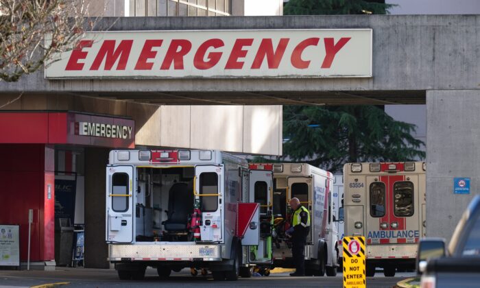 Ambulances are parked at the entrance to the emergency department at Richmond General Hospital, in Richmond, B.C., on Nov. 27, 2022. (The Canadian Press/Darryl Dyck)