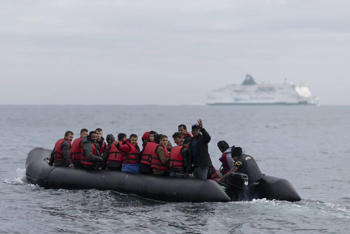 An inflatable craft carrying illegal immigrants crosses the shipping lane in the English Channel off the coast of Dover, England, on Aug. 4, 2022. (Dan Kitwood/Getty Images)