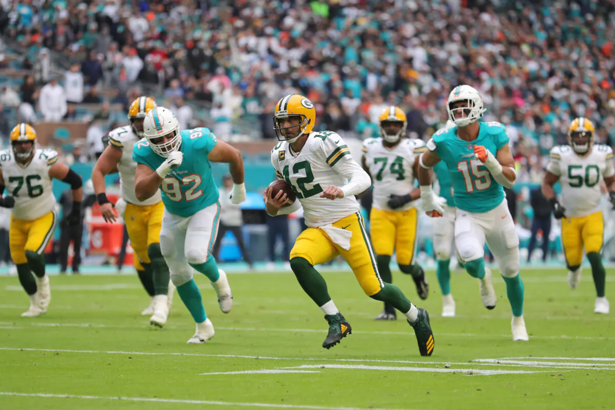 Aaron Rodgers (12) of the Green Bay Packers runs with the ball during the second half of the game against the Miami Dolphins at Hard Rock Stadium in Miami Gardens, Flor., on Dec. 25, 2022. (Megan Briggs/Getty Images)