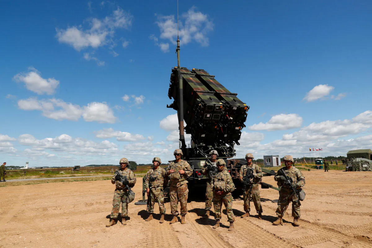 U.S. soldiers stand next to the long-range air defense system Patriot during Toburq Legacy 2017 air defense exercise in the military airfield near Siauliai, Lithuania, on July 20, 2017. (Ints Kalnins/Reuters)