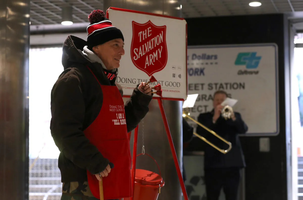 Salvation Army volunteer bell ringer San Arnold rings bells as he solicits donations at the Powell Street Bay Area Rapid Transit (BART) station in San Francisco on Dec. 3, 2019. (Justin Sullivan/Getty Images)