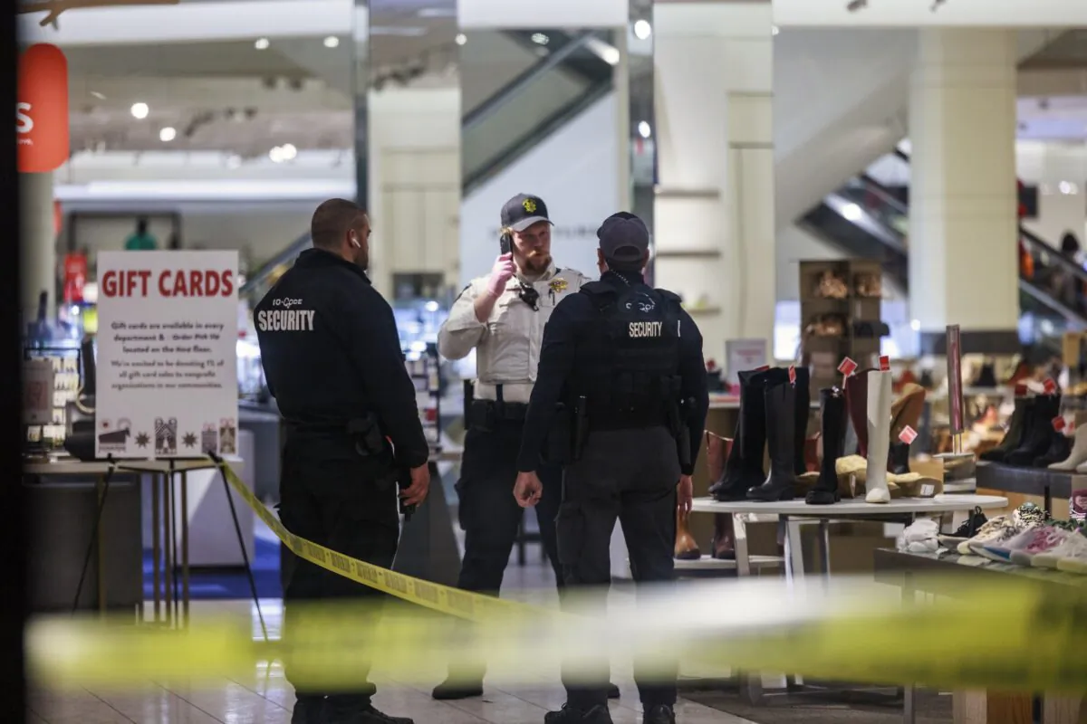 Security officers speak inside a store at the Mall of America in Bloomington, Minn., on Dec. 23, 2022, after reports of shots fired. (Kerem Yücel/Minnesota Public Radio via AP)