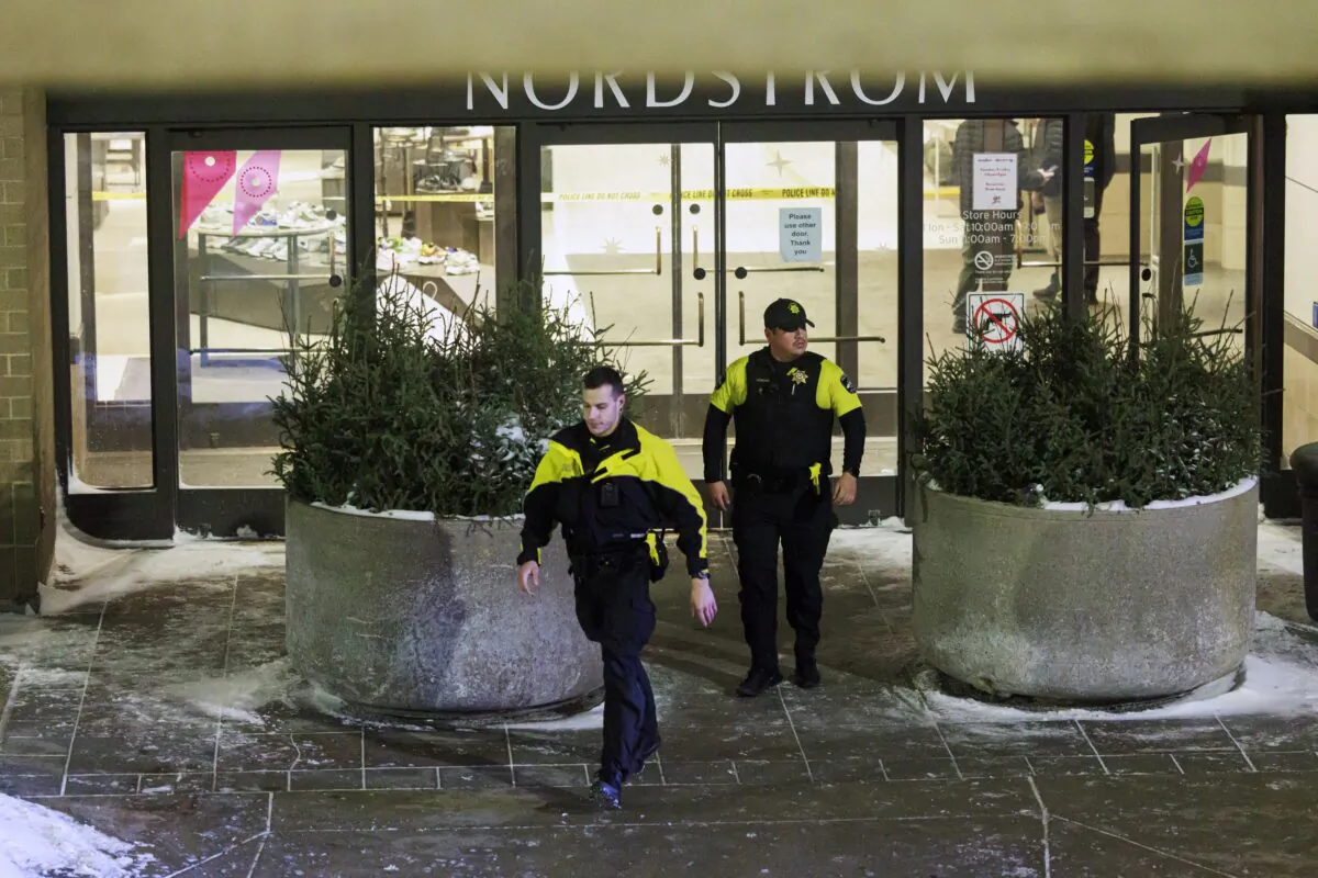 Two officers walk out of Nordstrom in Mall of America in Bloomington, Minn., on Dec. 23, 2022. (Kerem Yücel/Minnesota Public Radio via AP)