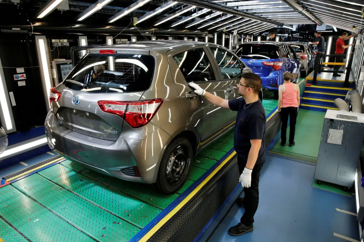 A Toyota Motor Corp. worker inspects a Yaris on the production line of the company's plant in Onnaing, near Valenciennes, France, on May 17, 2017. (Benoit Tessier/Reuters)