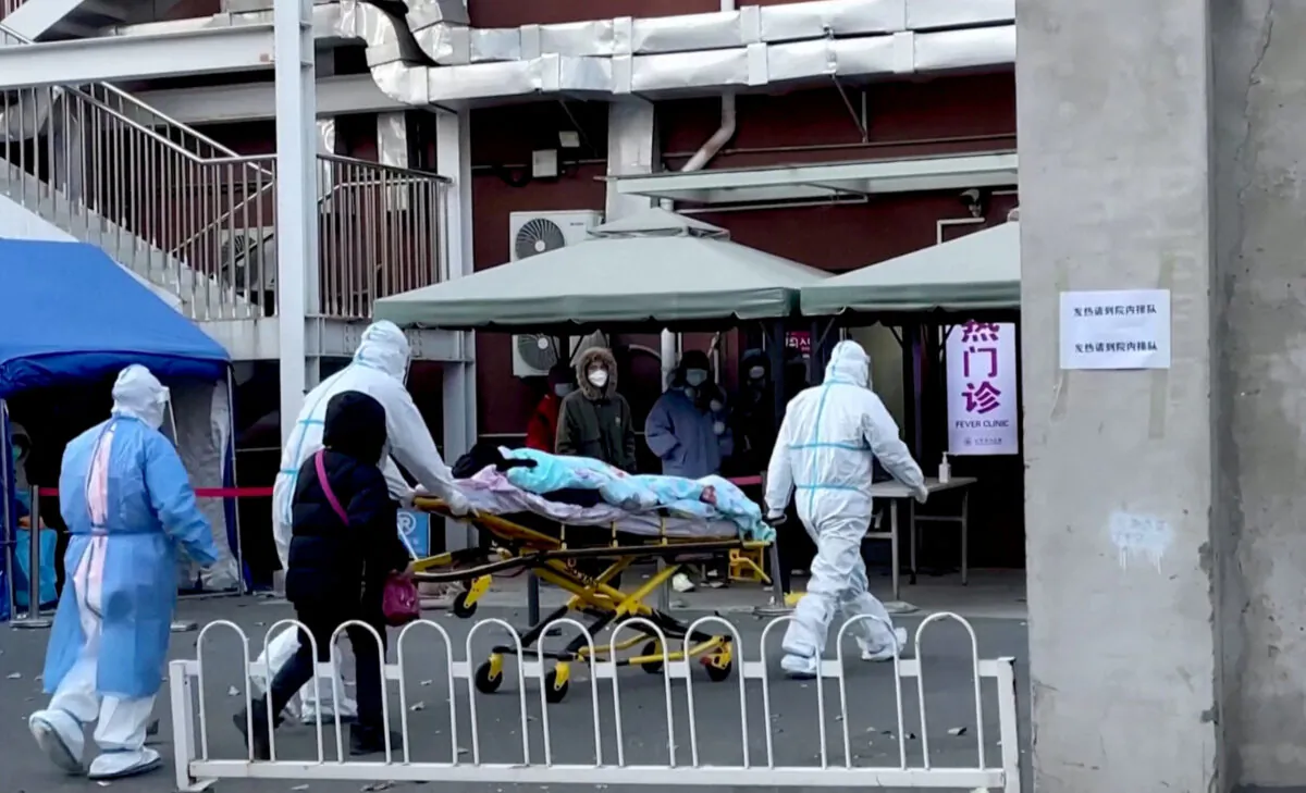 Medical staff moves a patient into a fever clinic at Chaoyang Hospital in Beijing, China, on Dec. 13, 2022. (Reuters TV via Reuters)