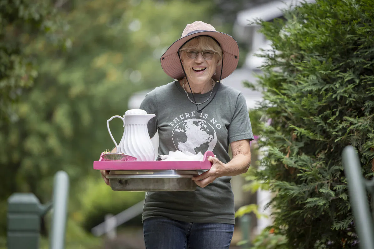 Betty Lotterman was all smiles as she brought coffee down for visitors to her home in St. Paul, Minn., on Sunday, Aug. 14, 2022. Beautiful Garden winner Betty Lotterman's garden is not only one of abundance but also serves as a garden for the greater good. It feeds the neighborhood with healthy, affordable food all while practicing sustainability and keeping the environment in mind. (Elizabeth Flores/Minneapolis Star Tribune/TNS)