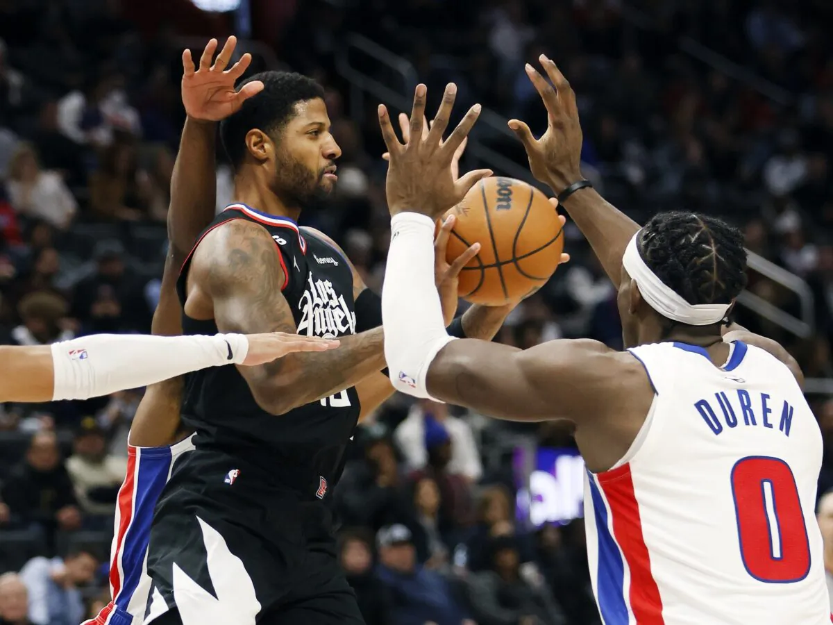 Los Angeles Clippers guard Paul George passes the ball against Detroit Pistons center Jalen Duren (0) during the first half of an NBA basketball game in Detroit on Dec. 26, 2022. (Duane Burleson/AP Photo)
