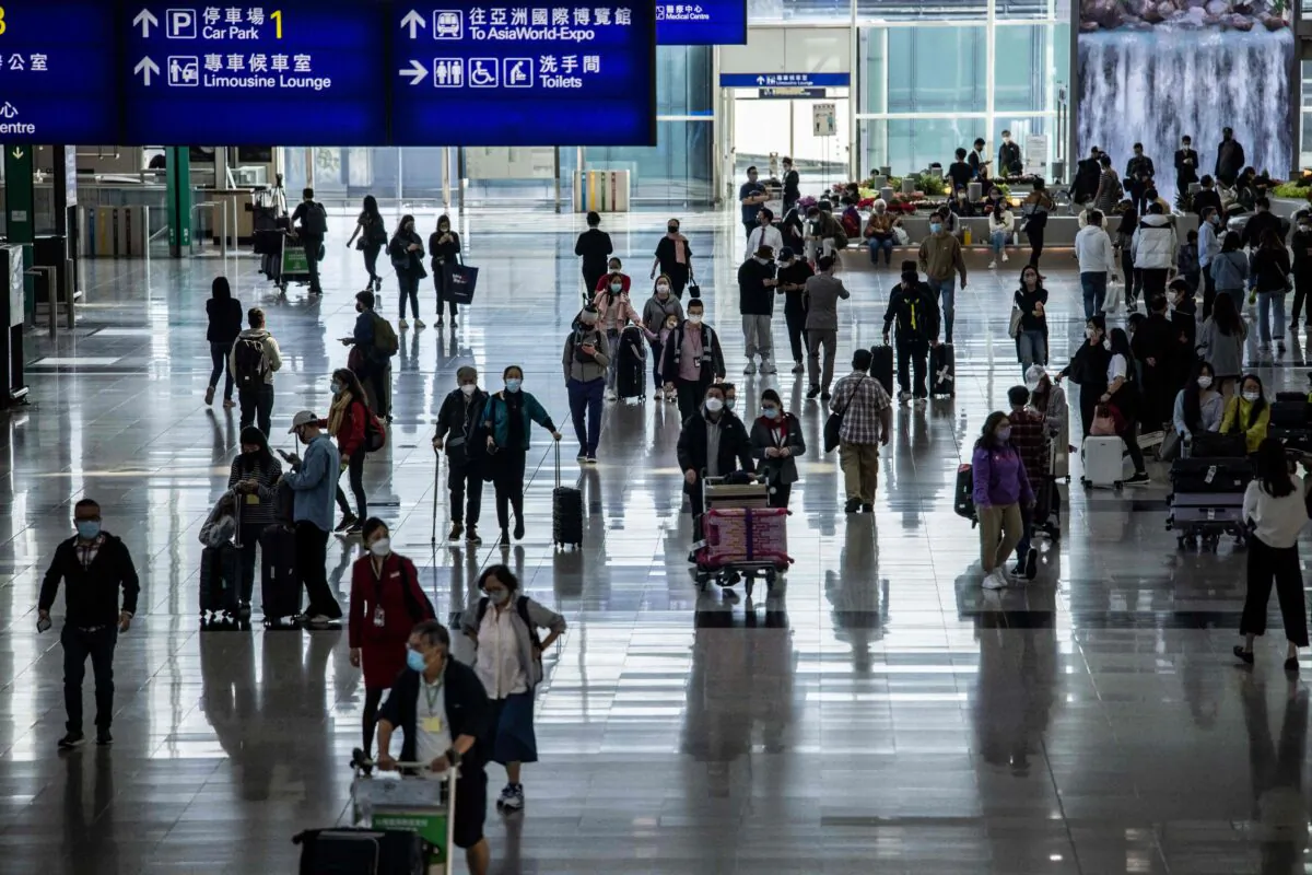 Passengers walk through the Hong Kong International Airport on Dec. 8, 2022. (Isaac Lawrence/AFP via Getty Images)