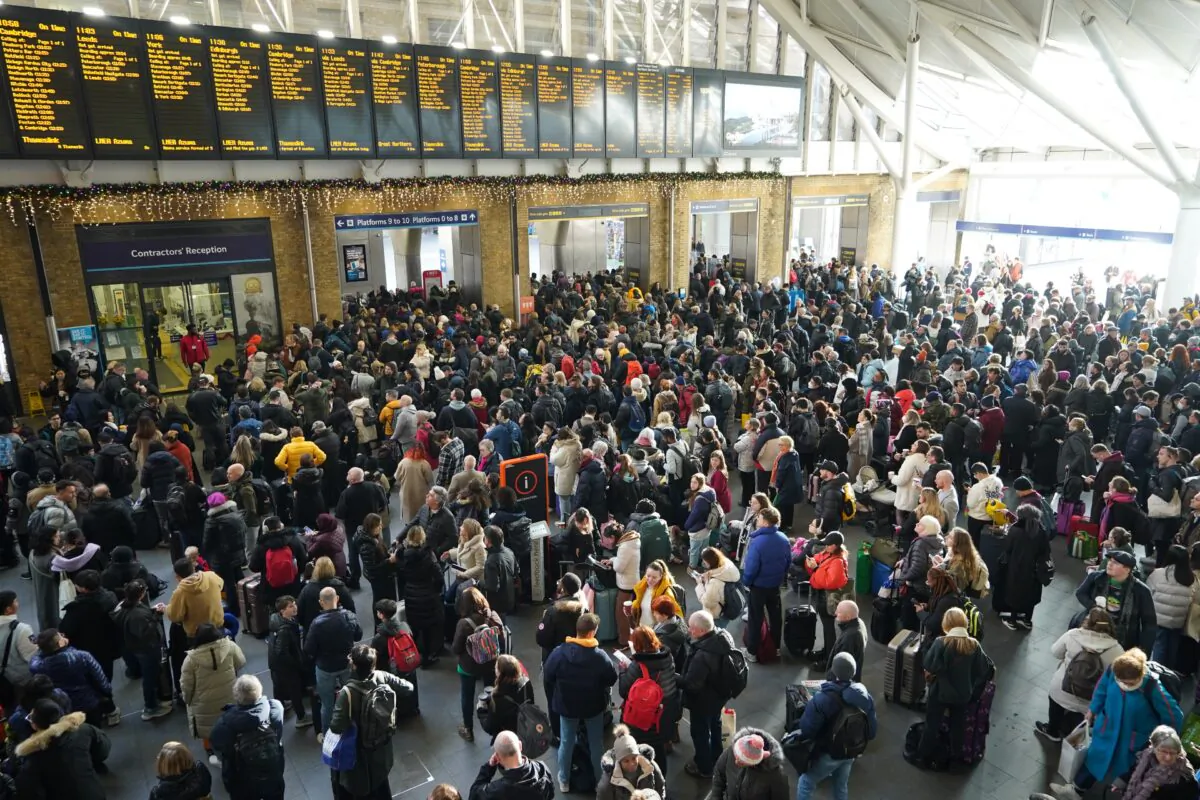 Passengers wait at the barriers at King's Cross station following a strike by members of the Rail, Maritime and Transport union (RMT), in London, on Dec. 27, 2022. (James Manning/PA Media)