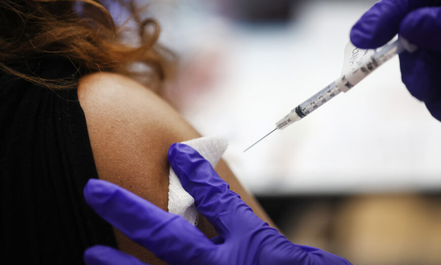 A nurse administers a COVID-19 vaccine booster to a person at a hospital in Hines, Ill., on April 1, 2022. (Scott Olson/Getty Images)