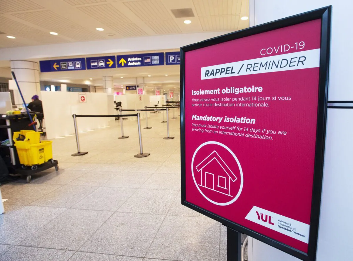 A sign reminds arriving passengers to quarantine against COVID-19 at Trudeau Airport in Montreal,Feb. 19, 2021. (The Canadian Press/Ryan Remiorz)
