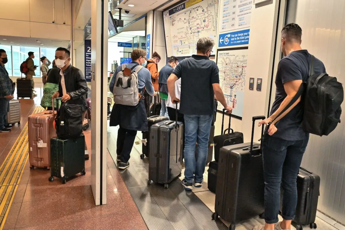 People queue to buy tickets into the city after their arrival at the international terminal of Tokyo's Haneda Airport on Oct.11, 2022. (Richard A. Brooks/AFP via Getty Images)