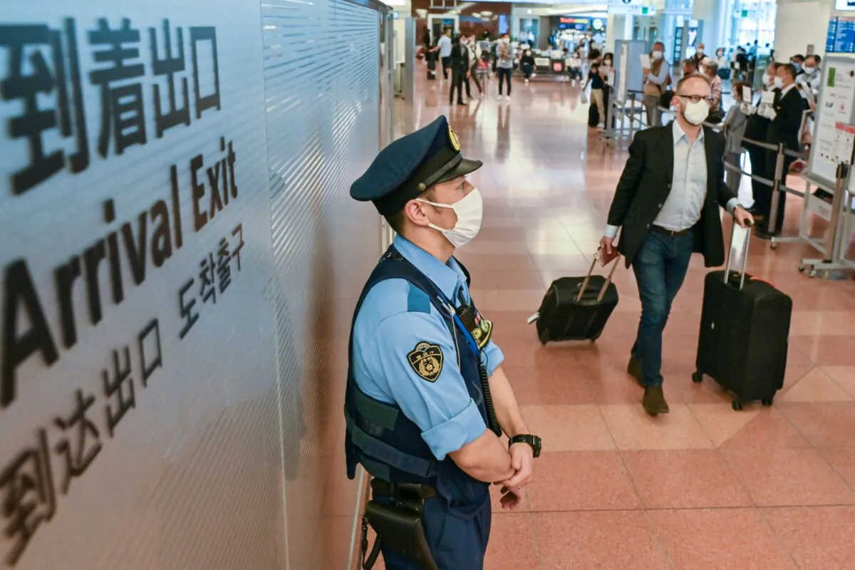 Passengers arrive at the international terminal of Tokyo's Haneda Airport on Oct. 11, 2022. Japan reopened to foreign travellers after two-and-a-half years of COVID restrictions. (Richard A. Brooks/AFP via Getty Images)
