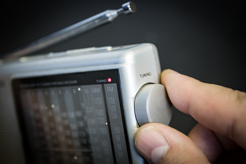 Portable,Radio,(fm,And,Shortwave);,Man's,Hand,On,Tuning,Dial.