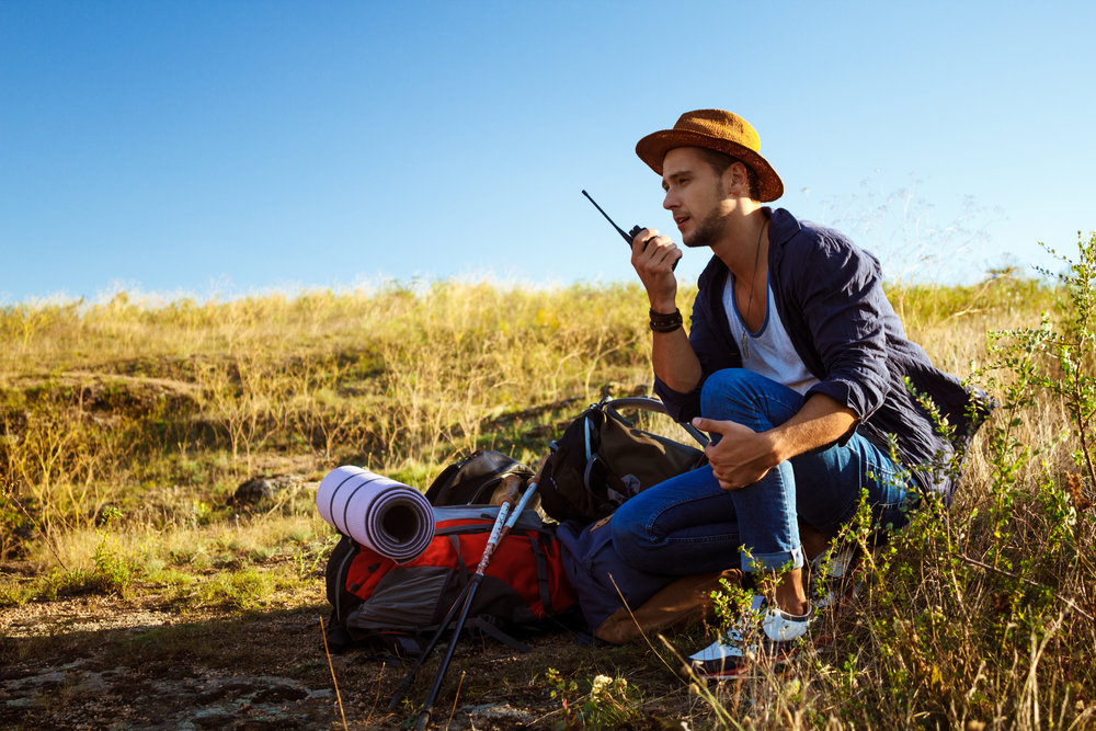 Young,Handsome,Man,Talking,On,Walkie,Talkie,Radio,,Enjoying,Canyon