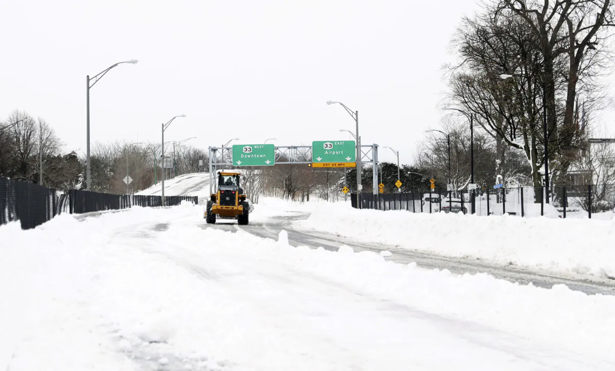 Legend Excavating owner Travis Storer works to remove snow off Route 33 in Buffalo, N.Y., on Dec. 27, 2022. (Joseph Cooke/The Buffalo News via AP)