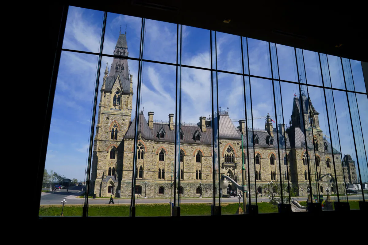 The West Block of Parliament Hill is seen through the window of the Sir John A. Macdonald building in Ottawa on May 11, 2022. (The Canadian Press/Sean Kilpatrick)