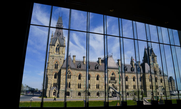 The West Block of Parliament Hill is seen through the window of the Sir John A. Macdonald building in Ottawa on May 11, 2022. (The Canadian Press/Sean Kilpatrick)