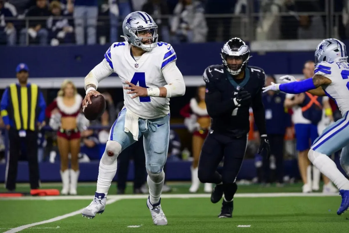 Dallas Cowboys quarterback Dak Prescott (4) rolls out to avoid the rush by Philadelphia Eagles linebacker Haason Reddick (7) during the second half at AT&T Stadium in Arlington, Texas, on Dec. 24, 2022. (Jerome Miron-USA TODAY Sports via Field Level Media)