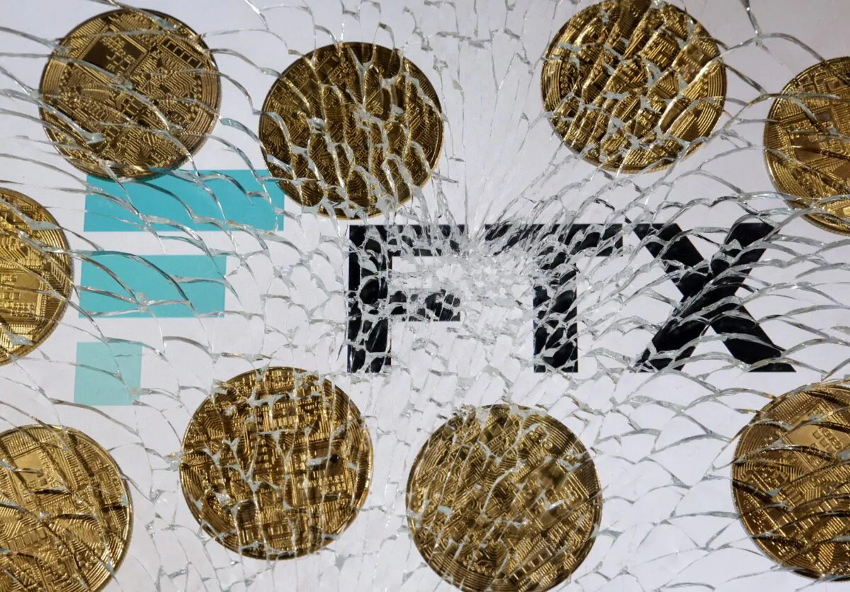 An FTX logo and a representation of cryptocurrencies are seen through broken glass in an illustration taken on Dec. 13, 2022. (Dado Ruvic/Illustration/Reuters)