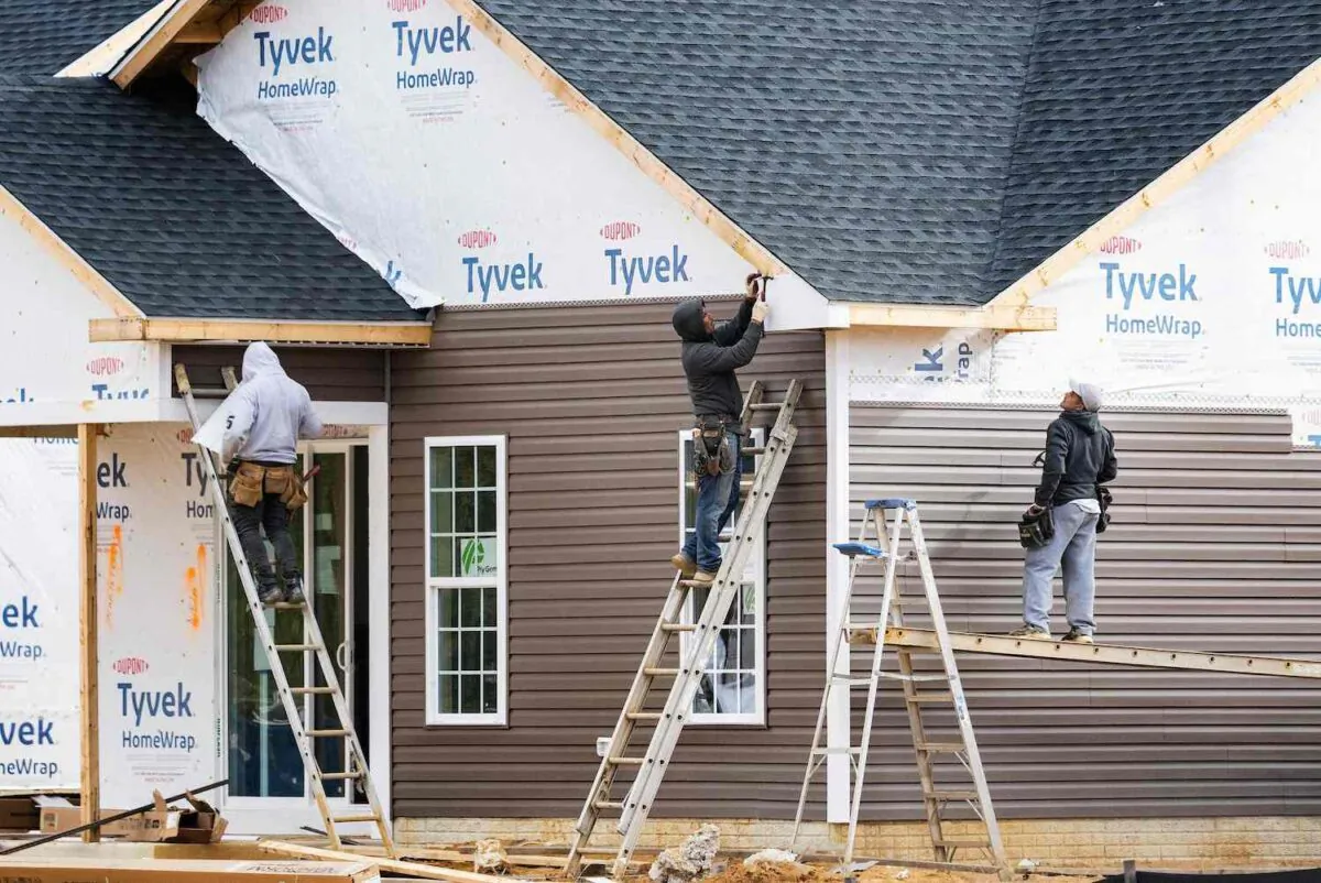 Workers attach siding to a house at a new home construction site in Trappe, Md., on Oct. 28, 2022. (Jim Watson/AFP via Getty Images)