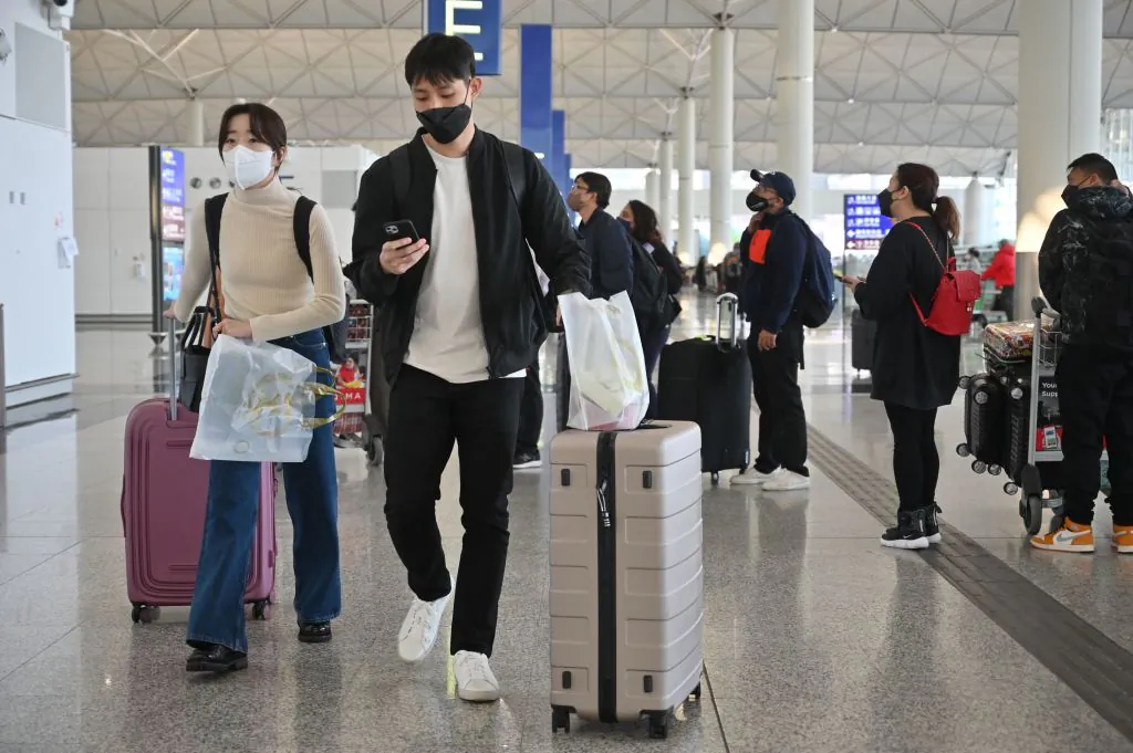 Passengers head to check-in counters at the international airport in Hong Kong on Dec. 28, 2022. (Peter Parks/AFP via Getty Images)