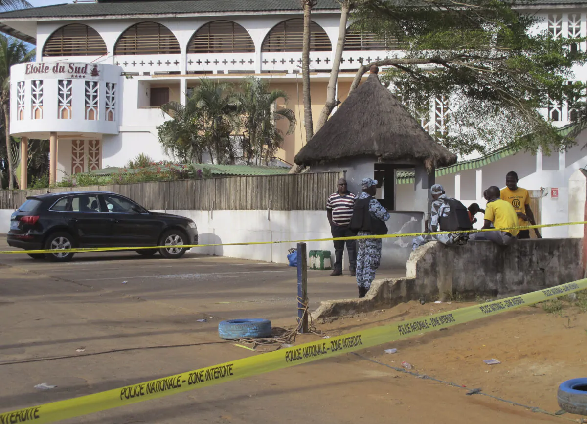 A road leading to the Etoile du Sud Hotel, seen in the background, is cordoned off near the site of an attack in Grand-Bassam, Ivory Coast, on March 15, 2016. (Carley Petesch/AP Photo)