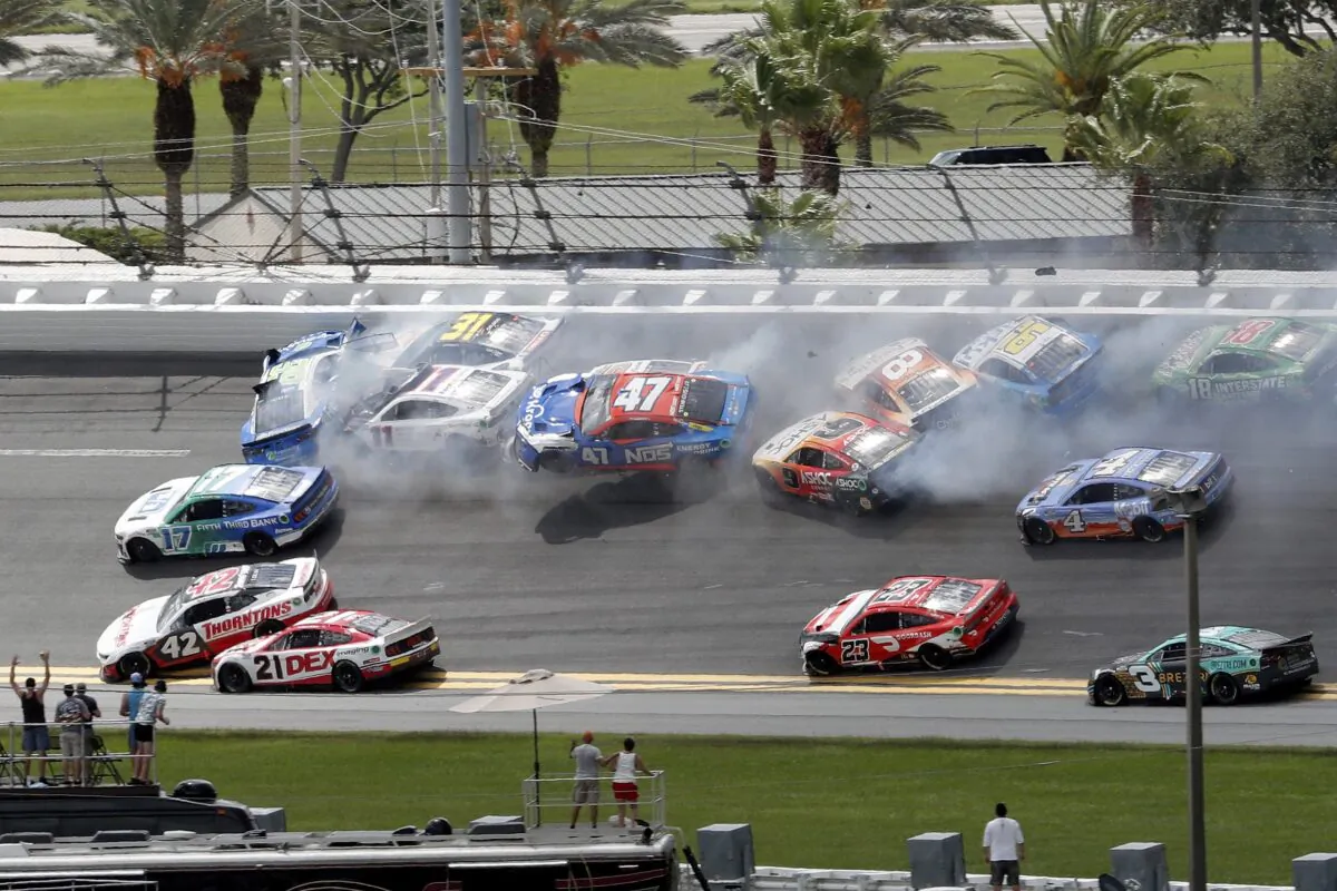 Chris Buescher (17), Daniel Suarez (99), Denny Hamlin (11), Justin Haley (31), Ricky Stenhouse Jr. (47), Aric Almirola (10), and others get involved in a multi-car accident between Turns 1 and 2 during a NASCAR Cup Series auto race at Daytona International Speedway in Daytona Beach, Fla., on Aug. 28, 2022. (David Graham/AP Photo)