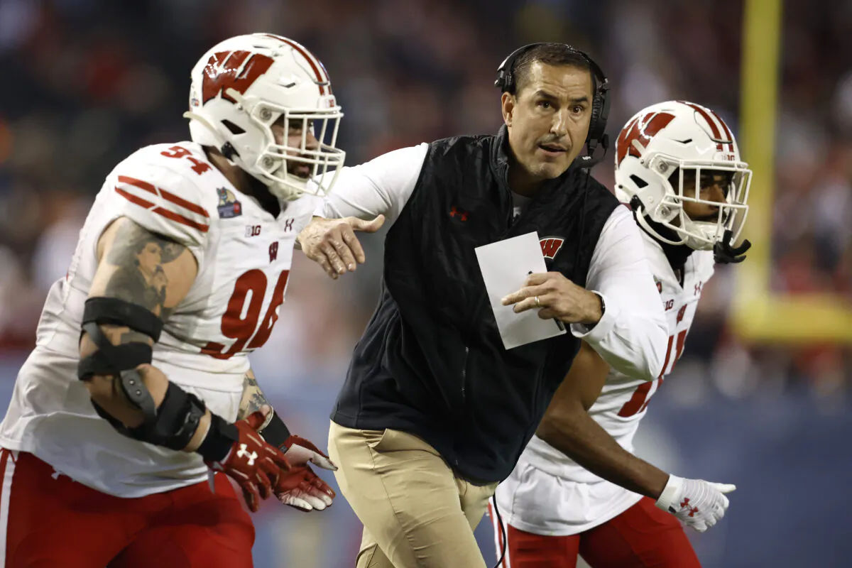 Head coach Luke Fickell of the Wisconsin Badgers runs onto the field to call a time out during the second half of the Guaranteed Rate Bowl against the Oklahoma State Cowboys at Chase Field in Phoenix on Dec. 27, 2022. (Chris Coduto/Getty Images)