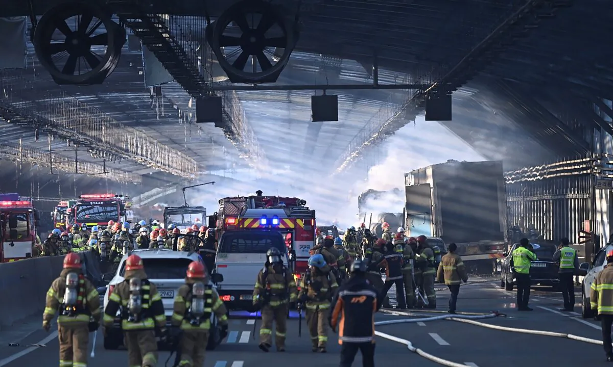 Firefighters work to extinguish a fire on a highway in Gwacheon, South Korea, on Dec. 29, 2022. (Kim Jong-taik/Newsis via AP)