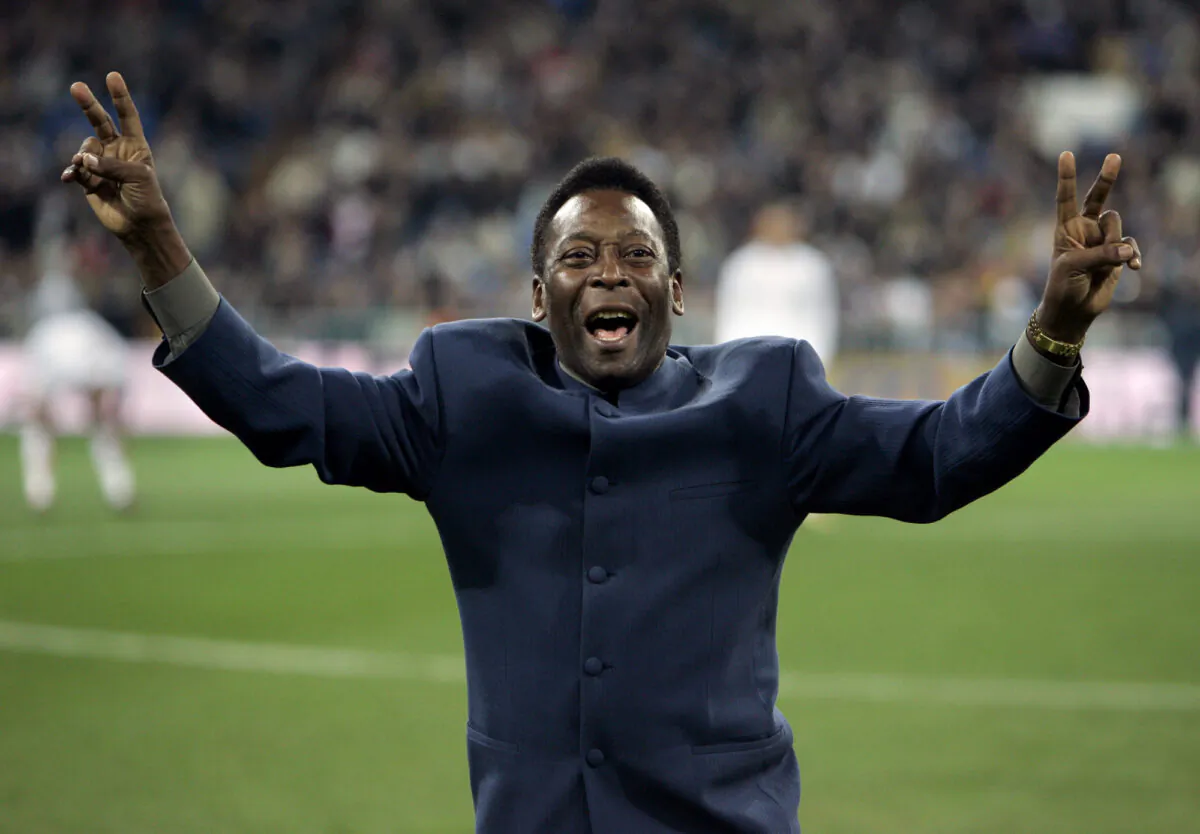 Brazil's soccer legend Pele greets the crowd ahead of a Spanish league soccer match, in the Santiago Bernabeu stadium in Madrid on Jan. 16, 2005. (Jasper Juinen/AP Photo)