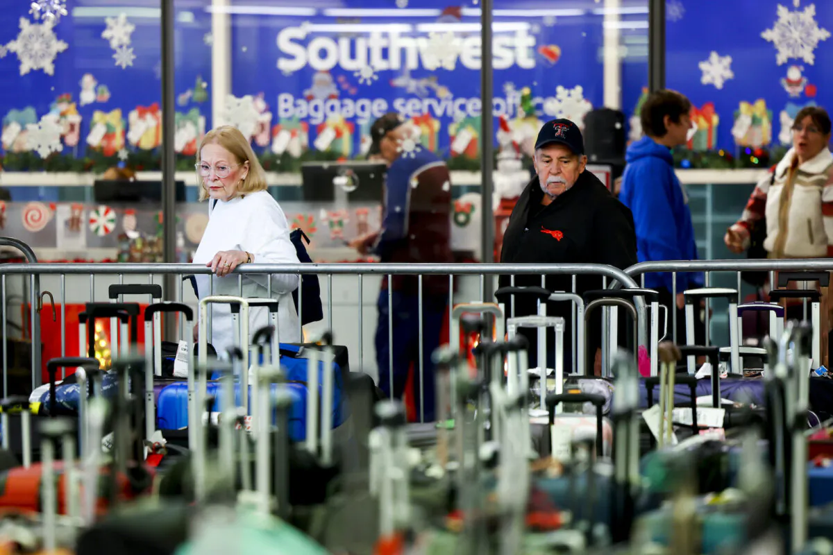 Travelers search for their suitcases in a baggage holding area for Southwest Airlines at Denver International Airport on in Denver, Colo., Dec. 28, 2022. (Michael Ciaglo/Getty Images)