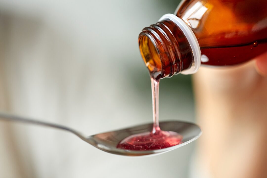 Bottle of medication or antipyretic syrup in a stock photo. (Ground Picture/Shutterstock)
