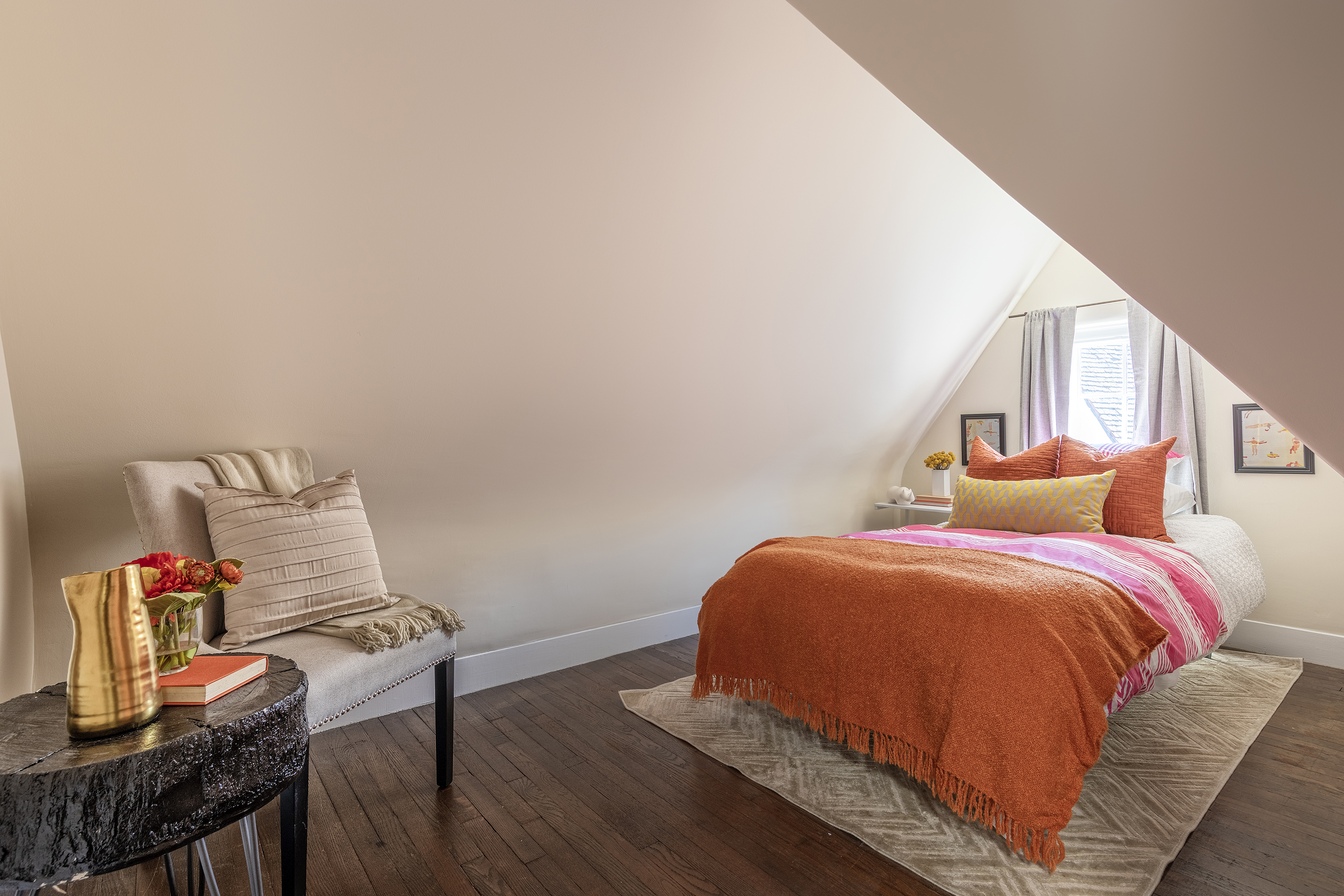 A bedroom with light shining in through a window